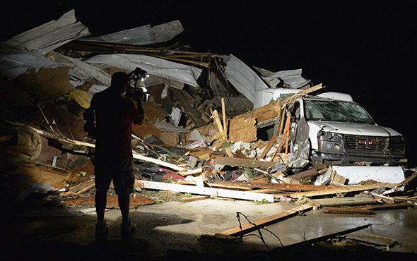 News video photographer Brad Mack covers the damage seen after a tornado hit the town of Mayflower, Arkansas.