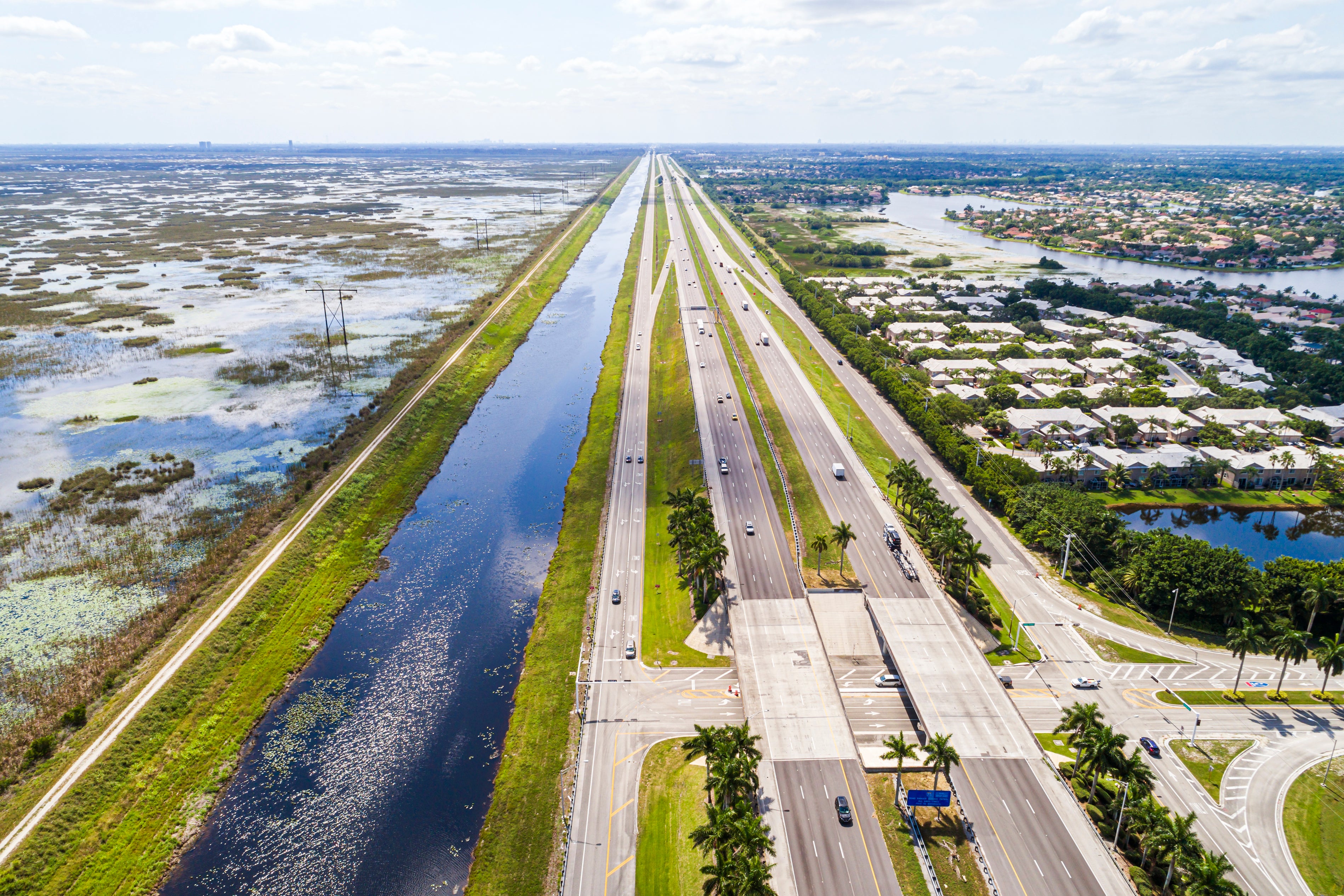 Florida wetlands developed for suburban sprawl, with roads running across it.