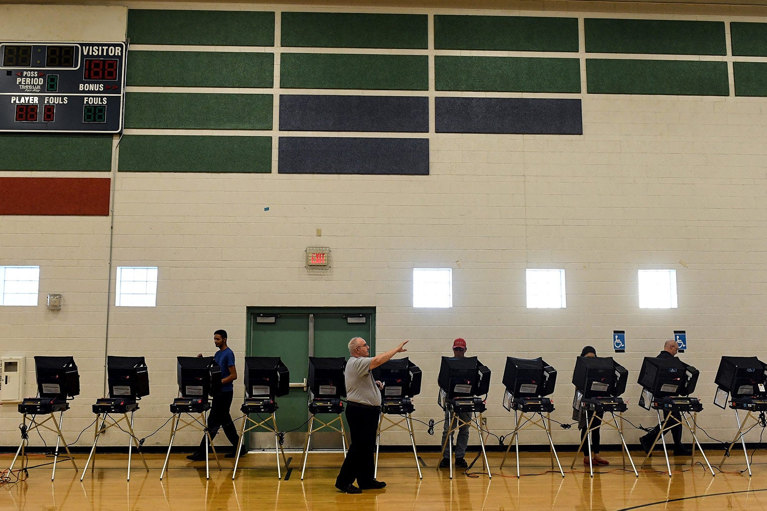 Voters cast their ballots at voting machines at Shadow Ridge High School.