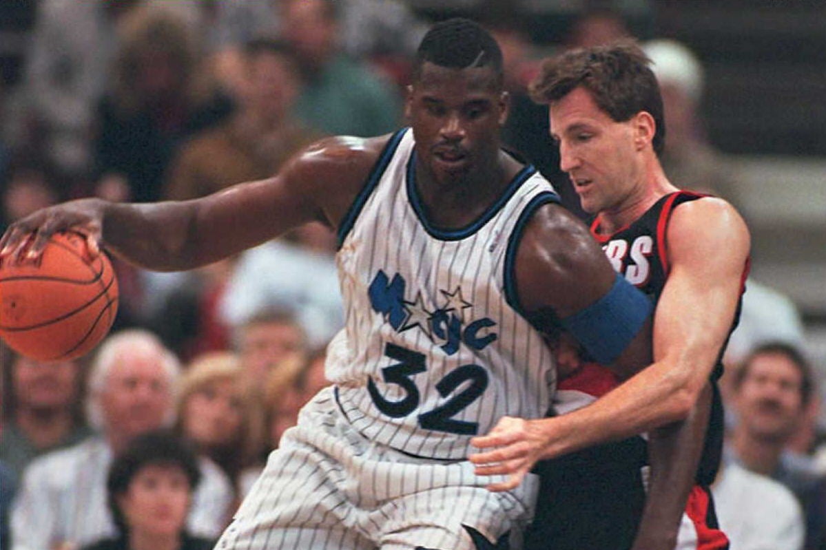 O'Neal, playing for the Orlando Magic against Dudley's Portland Trail Blazers, knocks Dudley backward in the post.