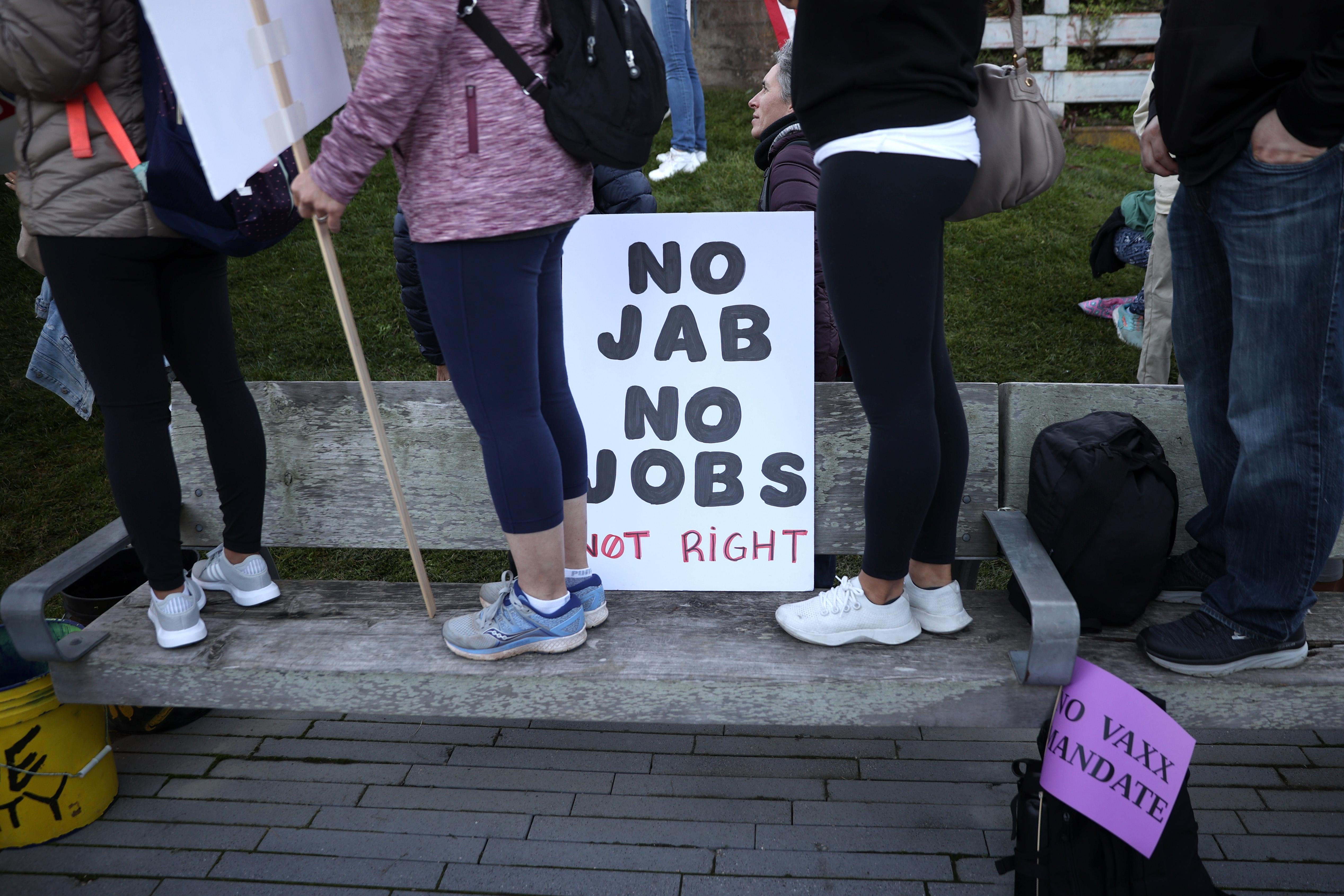 Protesters stand next to a sign during an anti-vaccination rally at the Golden Gate Bridge on November 11, 2021 in San Francisco, California.