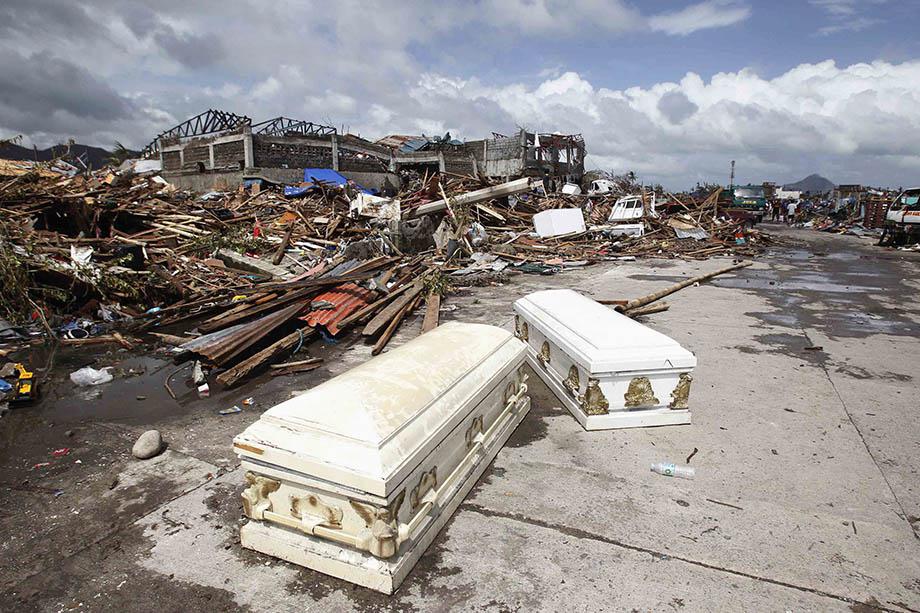 Empty coffins lie on a street near houses damaged after super Typhoon Haiyan battered Tacloban city, central Philippines.