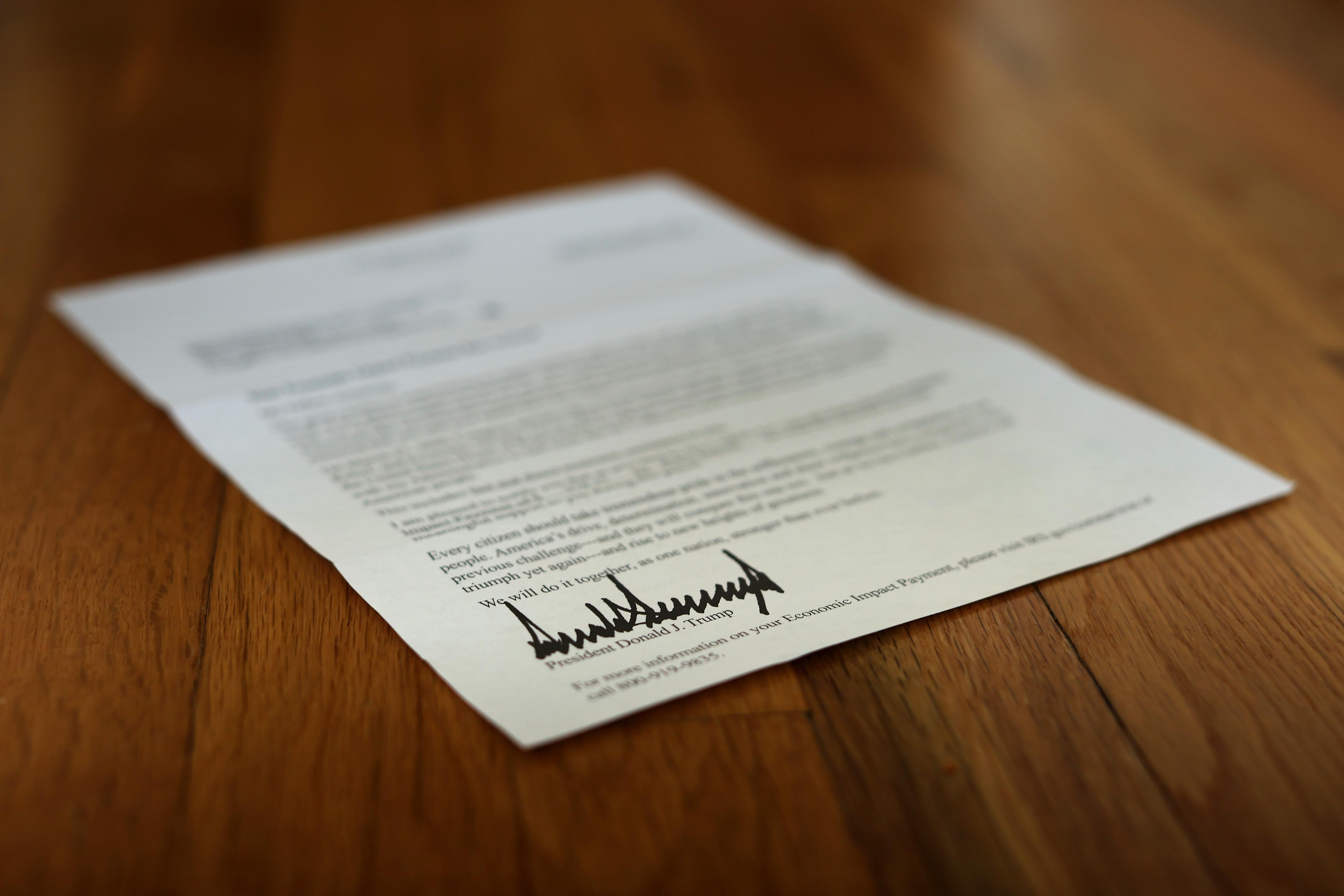 WASHINGTON, DC - APRIL 29: A letter bearing the signature of U.S. President Donald Trump was sent to people who received a coronavirus economic stimulus payment as part of the Cares Act April 29, 2020 in Washington, DC. The letter had a return address for the Internal Revenue Service in Austin, Texas, but was printed on White House letterhead. The initial 88 million payments totaling nearly $158 billion were sent by the Treasury Department last week as most of the country remains under stay-at-home orders due to the COVID-19 pandemic. (Photo by Chip Somodevilla/Getty Images)