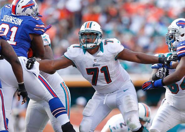 Jonathan Martin #71 of the Miami Dolphins defends along the line against the Buffalo Bills on December 23, 2012 at Sun Life Stadium in Miami Gardens, Florida. 