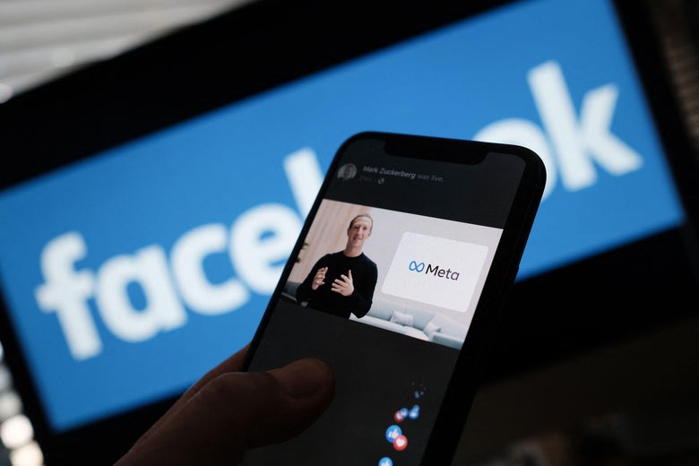A person watches on a smartphone Facebook CEO Mark Zuckerberg unveil the META logo