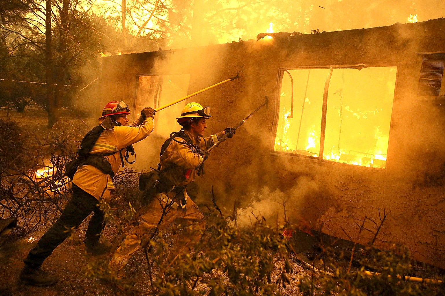 Firefighters try to contain a house on fire in California.