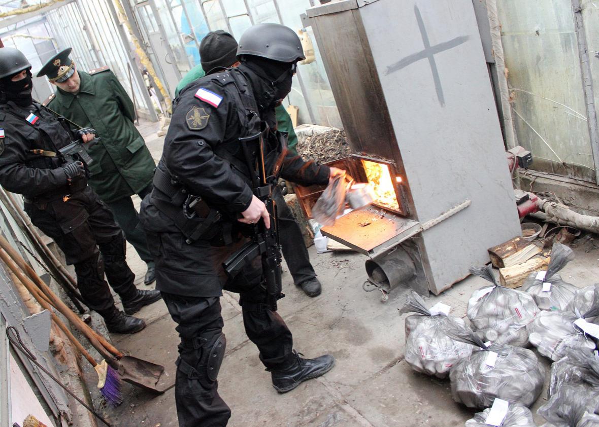 Russian Federal Drug Control Service officers burn bags of synthetic opioid Methadone