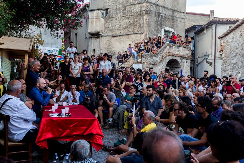 People gathering in the town of Riace.