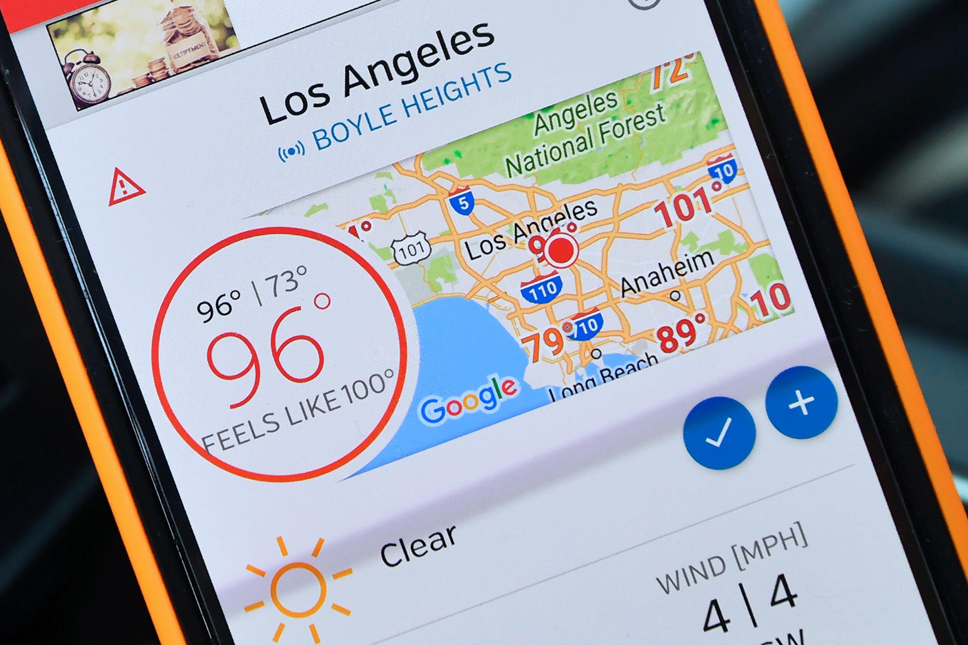 A weather app on a mobile phone shows its 96 degrees in the shade. 