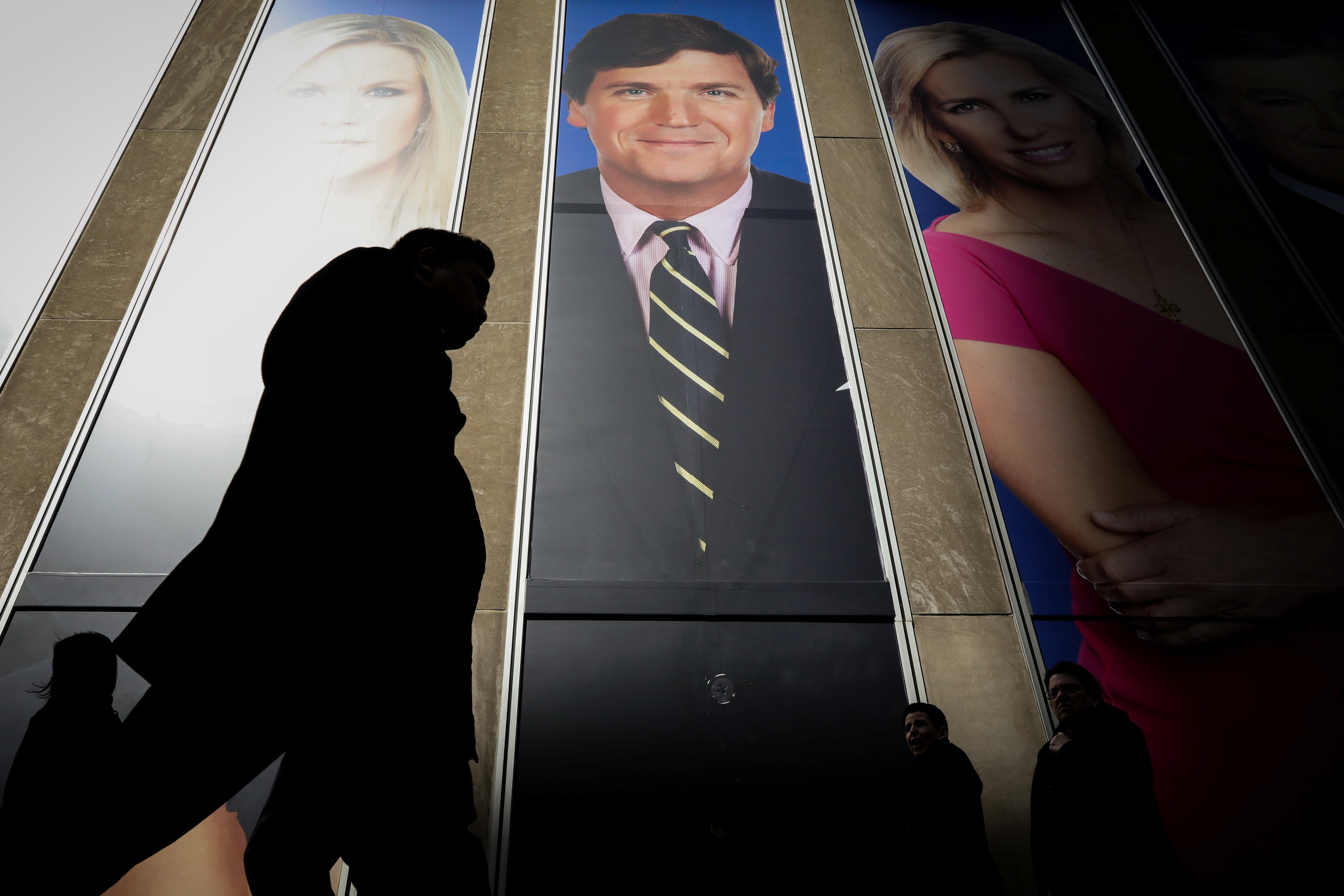 A promo of Tucker Carlson on the Fox News building in New York City. 