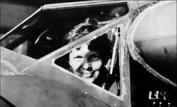 Amelia Earhart looks through the cockpit window of her plane