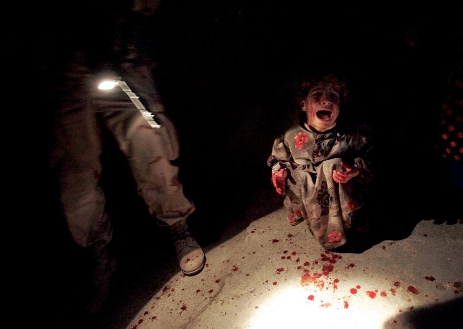 TAL AFAR, Iraq—Samar Hassan, 5, screams moments after her parents were killed by U.S. soldiers from the 25th Infantry Division. The troops fired on the Hassan family car when it unwittingly approached during a dusk patrol in the tense northern town. Her brother, Racan, 11, was wounded in the shooting. Later, after being treated in the U.S. and returning to Iraq, Racan was killed when insurgents bombed the family home in retaliation for the boy’s trip to the U.S., Jan. 18, 2005.