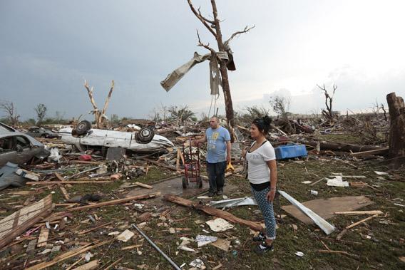stand in the rubble of his house after a powerful tornado ripped through the area on May 20, 2013 in Moore, Oklahoma. 