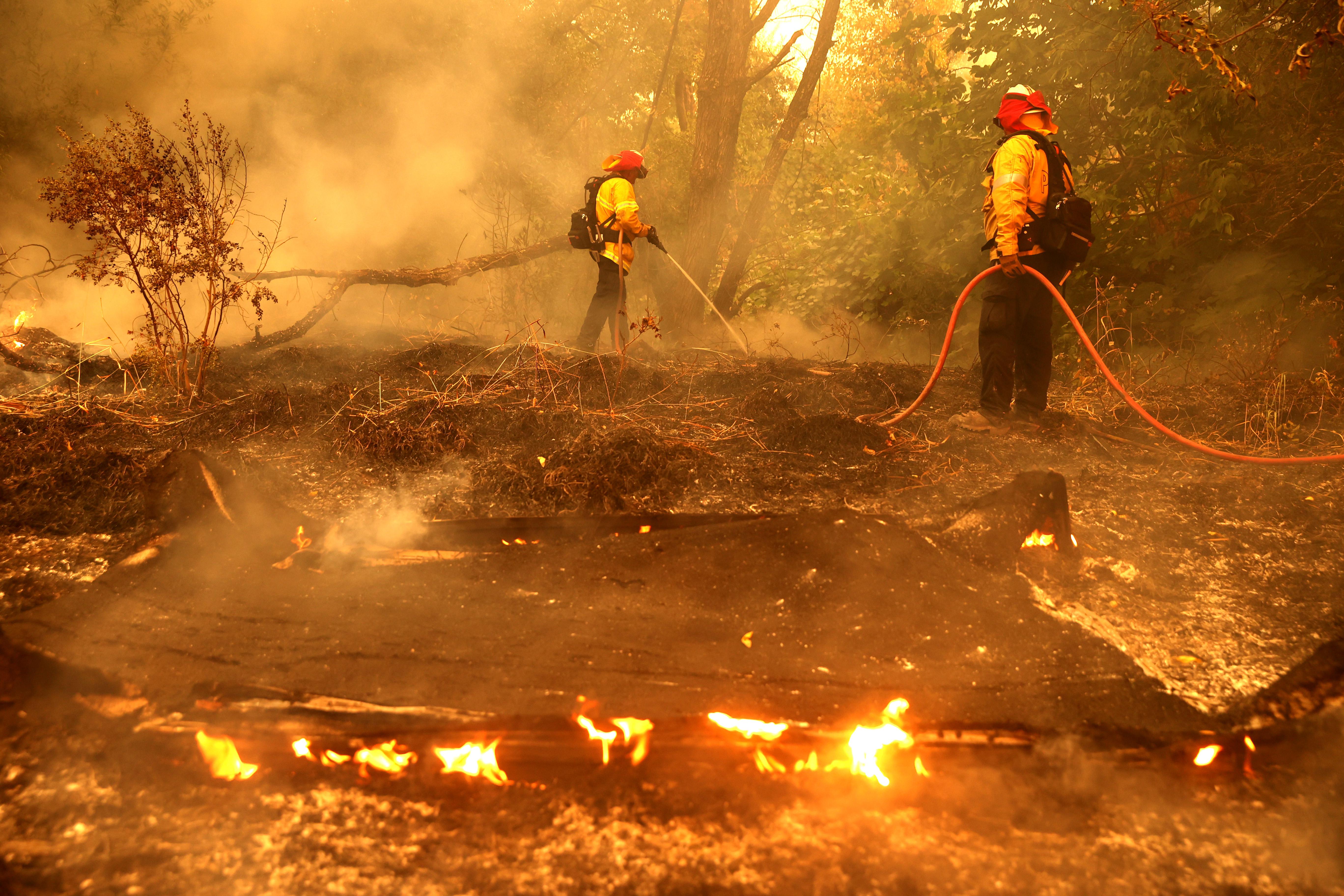 Firefighters extinguish spot fires.