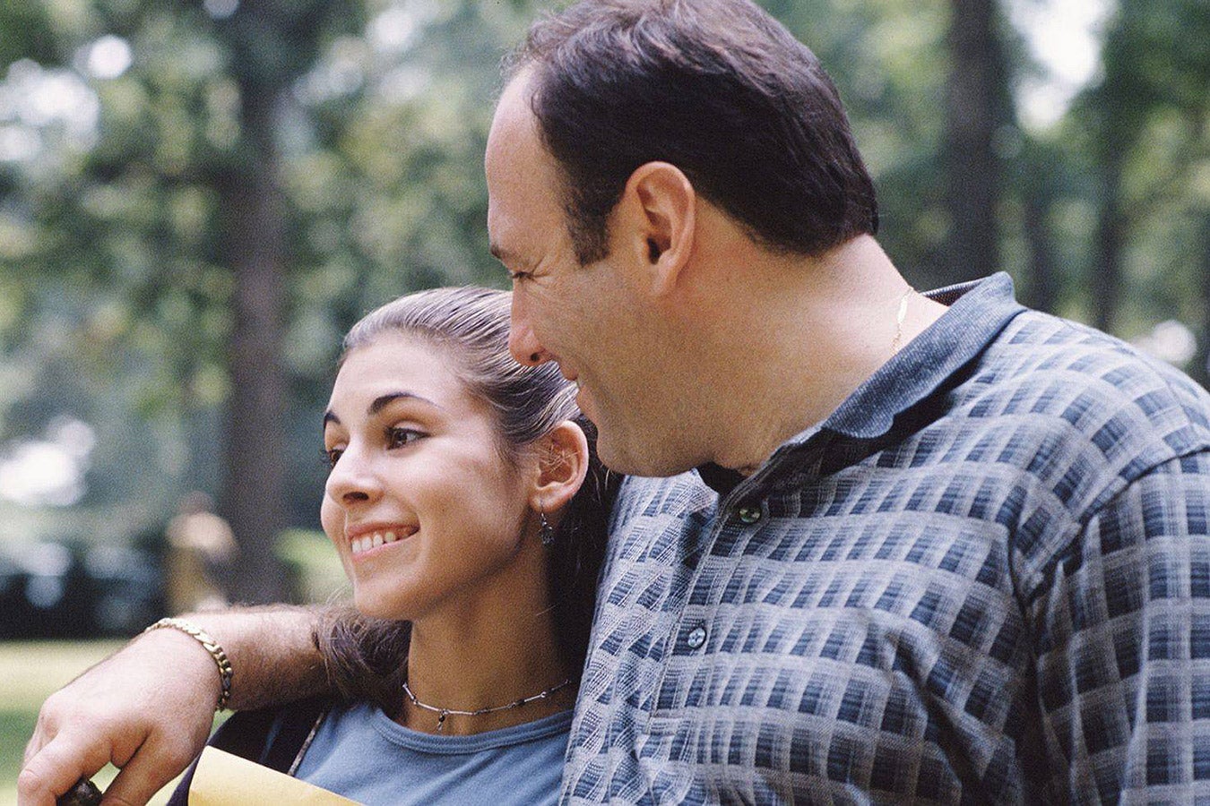 Tony Soprano puts his arm around Meadow as they walk outside and smile.