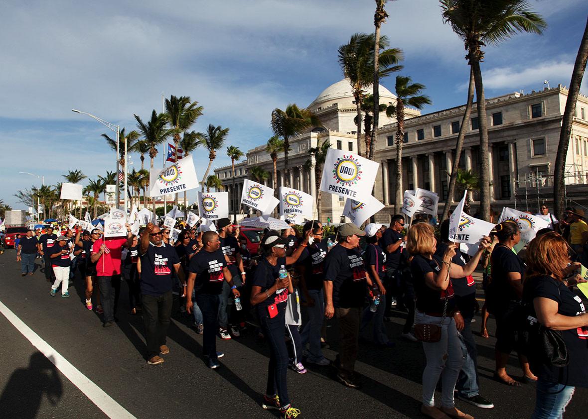 Members of labor unions march past the capitol building during a protest in San Juan September 11, 2015. 