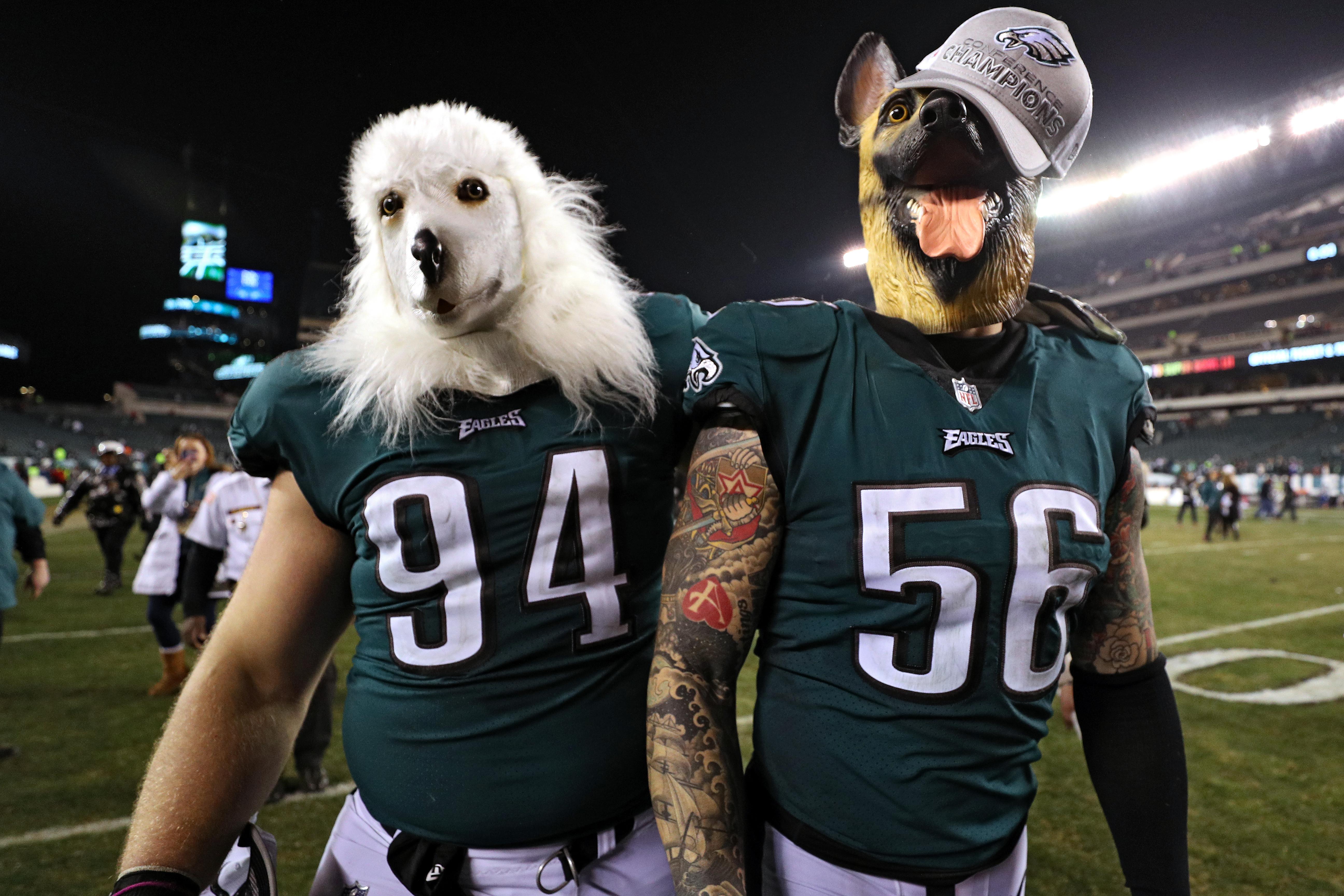 Dog-mask-wearing Beau Allen #94 and Chris Long #56 of the Philadelphia Eagles celebrate their team's win over the Minnesota Vikings.