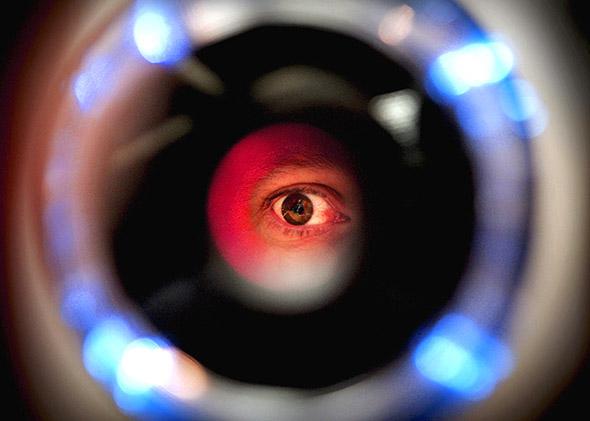 A man uses an iris recognition scanner.