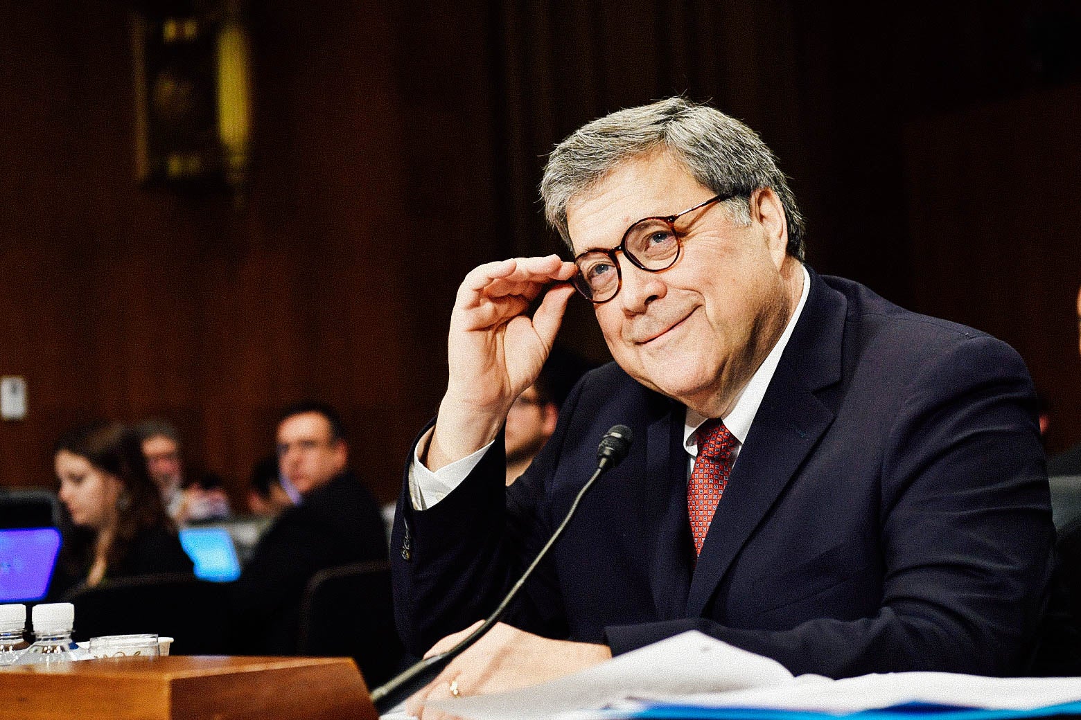 Attorney General William Barr smiles and adjusts his glasses while testifying before the Senate Judiciary Committee on Wednesday in Washington.