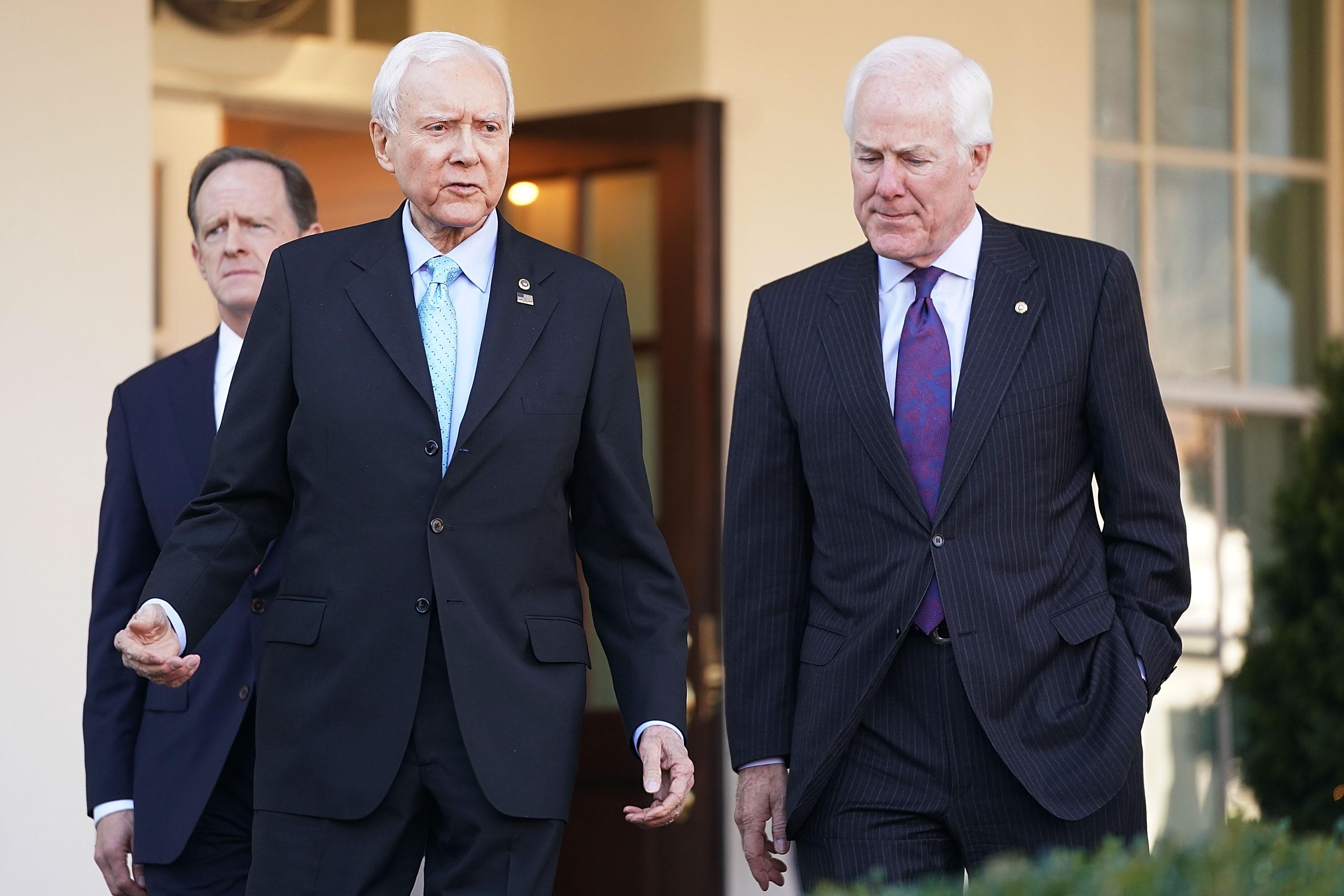 WASHINGTON, DC - NOVEMBER 27:  Senate Finance Committee members Sen. Pat Toomey (R-PA) (L) and Sen. John Cornyn (R-TX) (R) walk out of the West Wing with Chairman Orrin Hatch (R-UT) following a lunch meeting with U.S. President Donald Trump at the White House November 27, 2017 in Washington, DC. Senate Republicans hope to pass tax reform and tax cut legislation this week and move closer to Trump's goal of signing it before the end of the year.  (Photo by Chip Somodevilla/Getty Images)