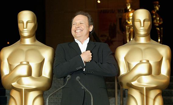 Actor Billy Crystal mimics the Oscar statues at the Academy of Motion Picture Arts and Sciences