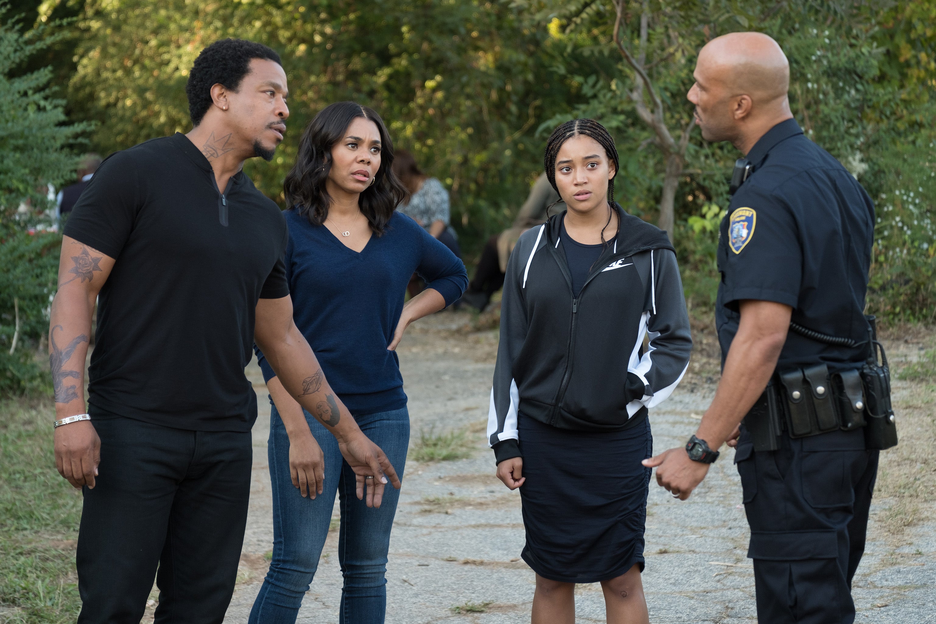 Russell Hornsby, Regina Hall, Amandla Stenberg, and Common. Common wears a navy police uniform.