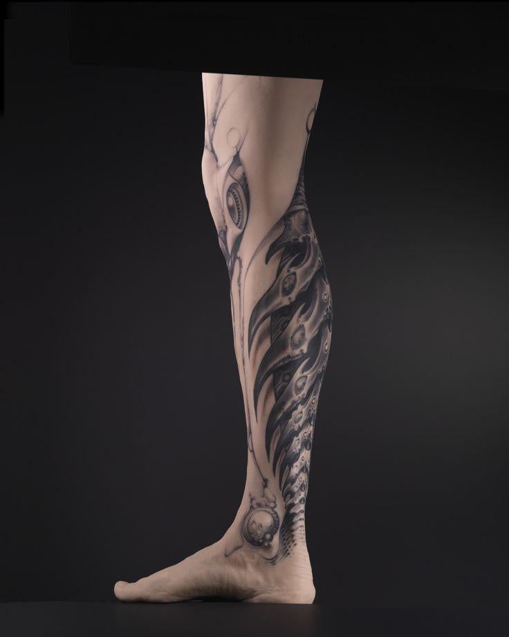 Tattoo designed by Grime on the silicone cast of a man's leg.