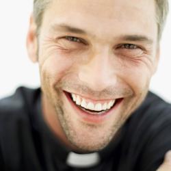 Portrait of a smiling priest.