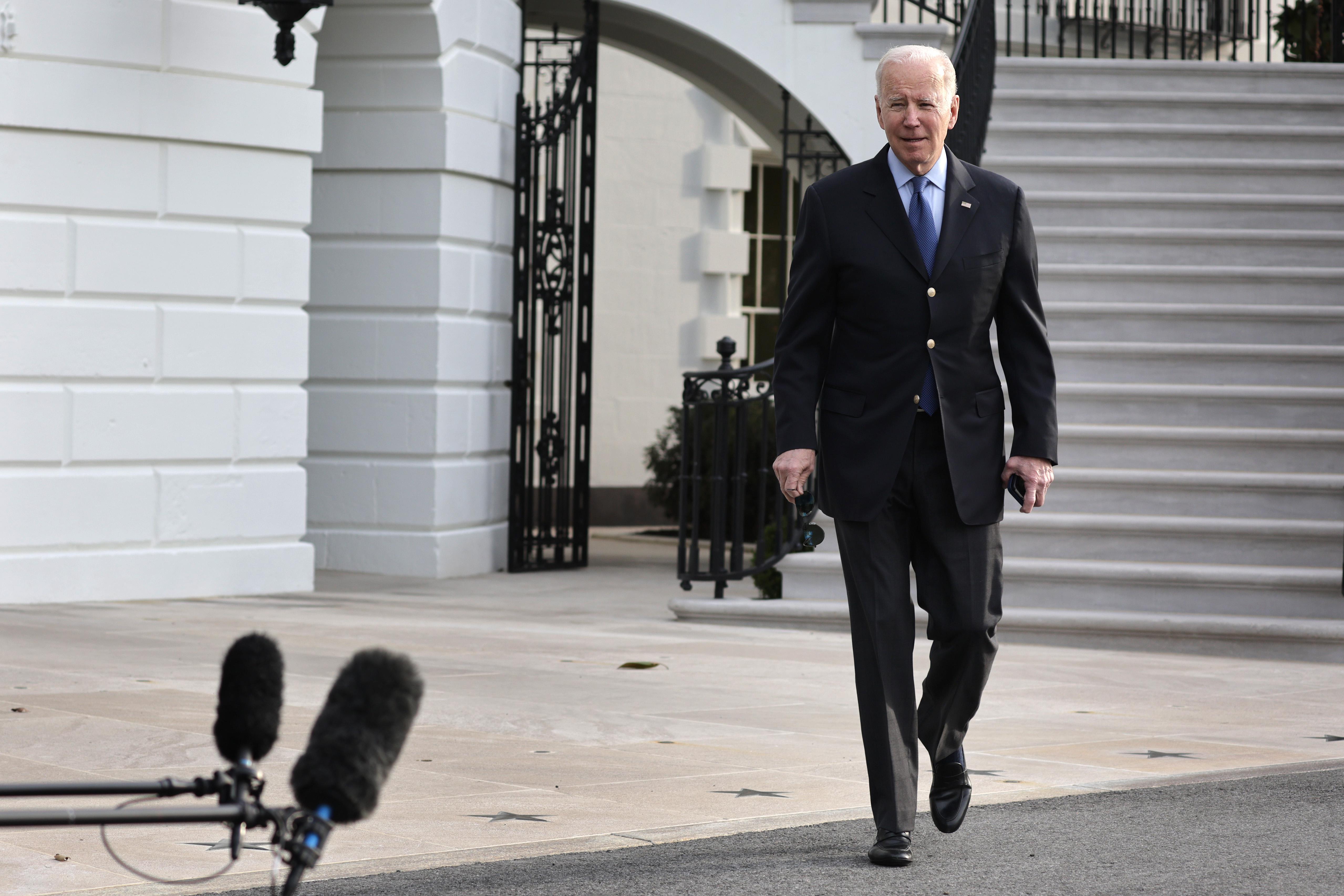 President Joe Biden walks toward members of the press prior to a Marine One departure from the White House on March 23, 2022 in Washington, D.C.