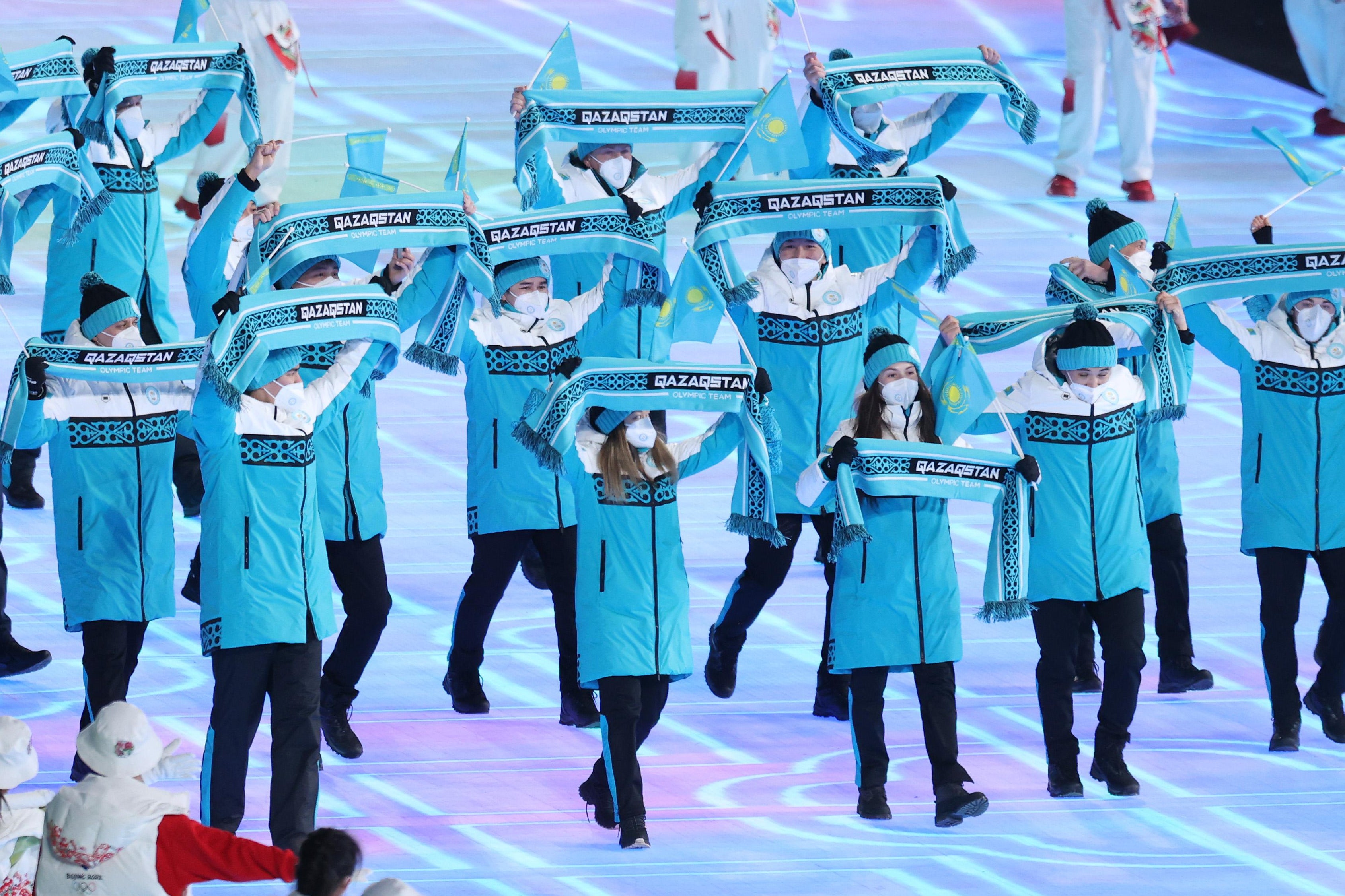 Members of Team Kazakhstan wave their scarves.