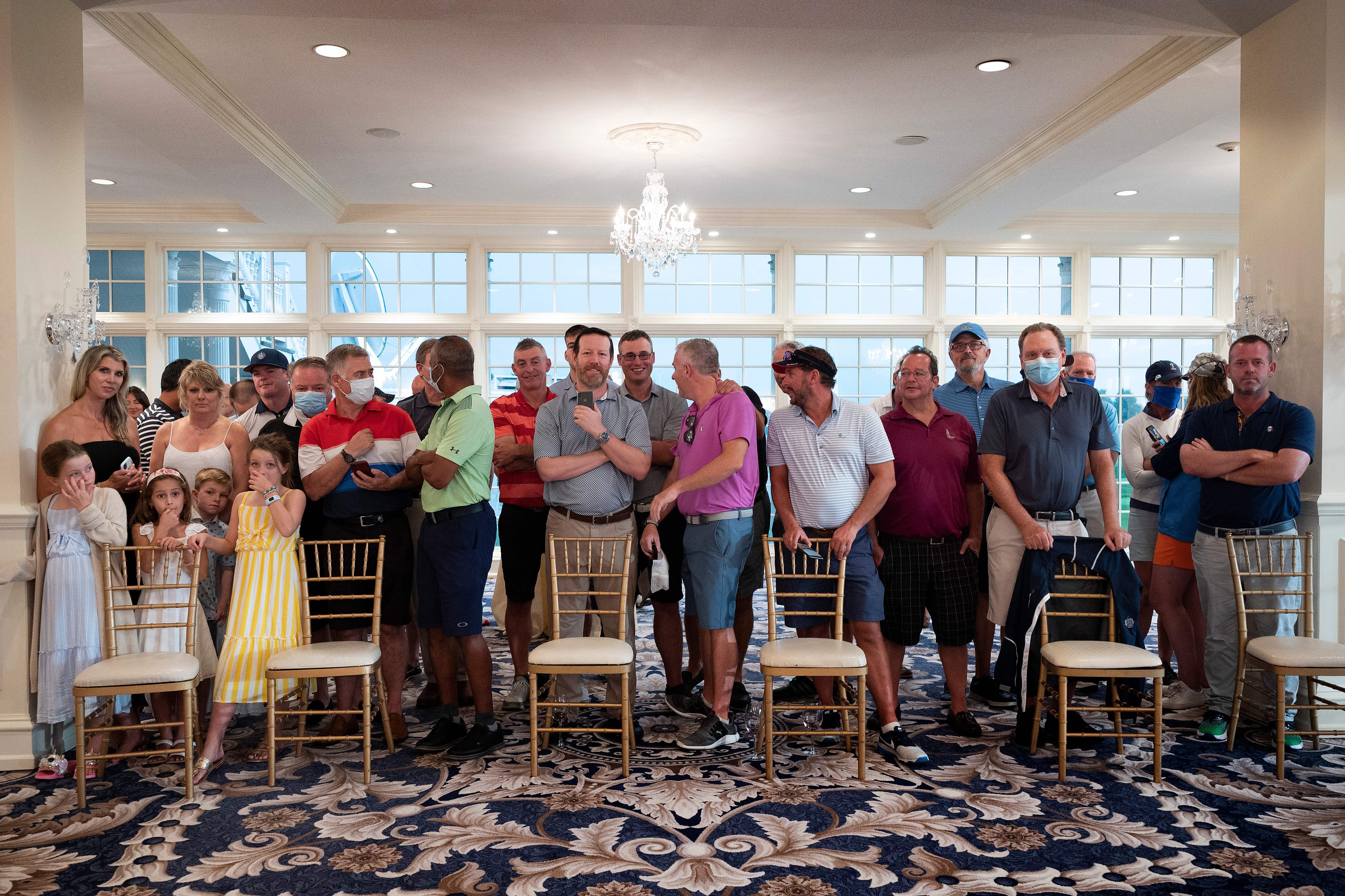 Country club members, few wearing facemasks, await the president's arrival ahead of a news conference in Bedminster, New Jersey, on August 7, 2020.