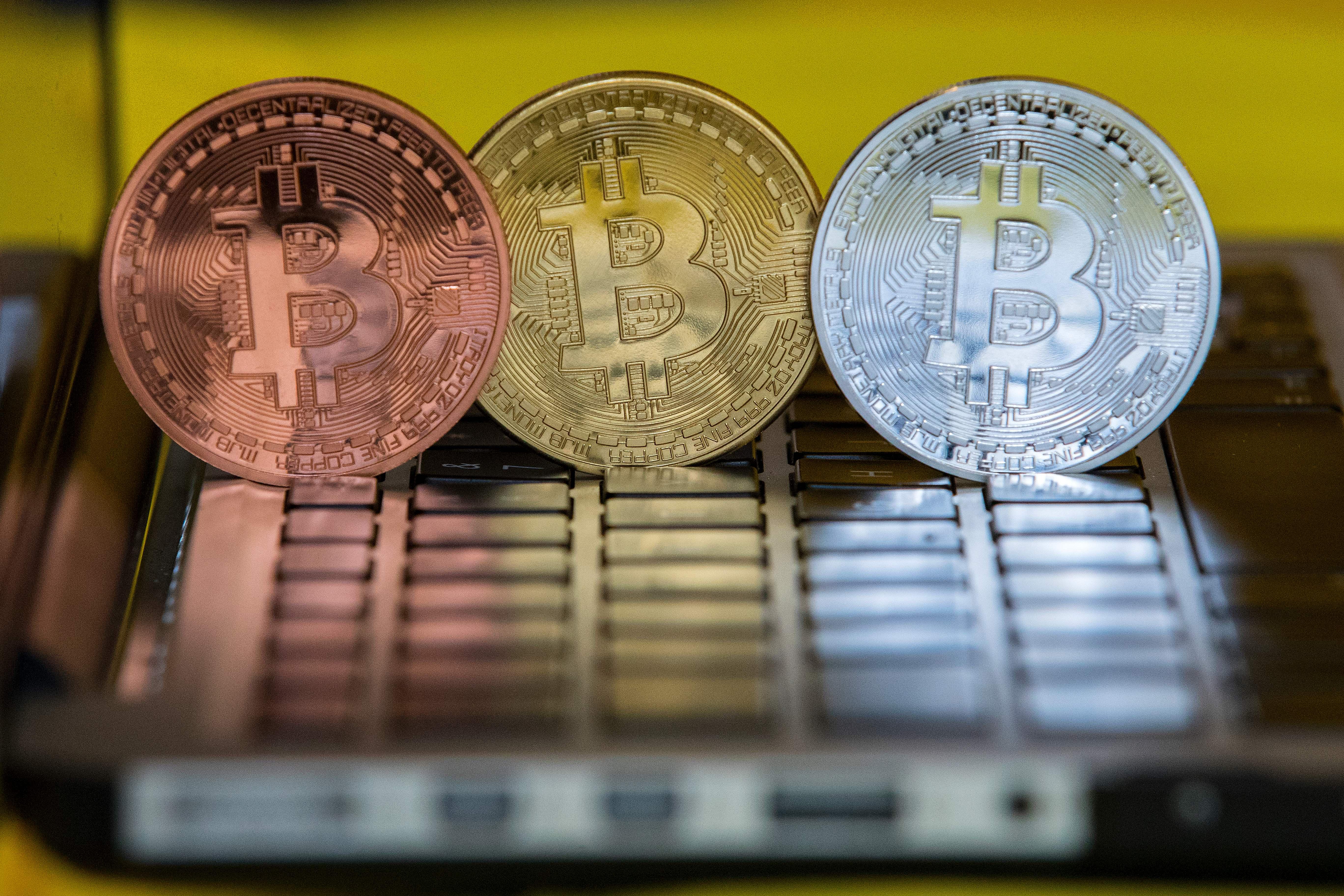 Bitcoins perched on a laptop. 