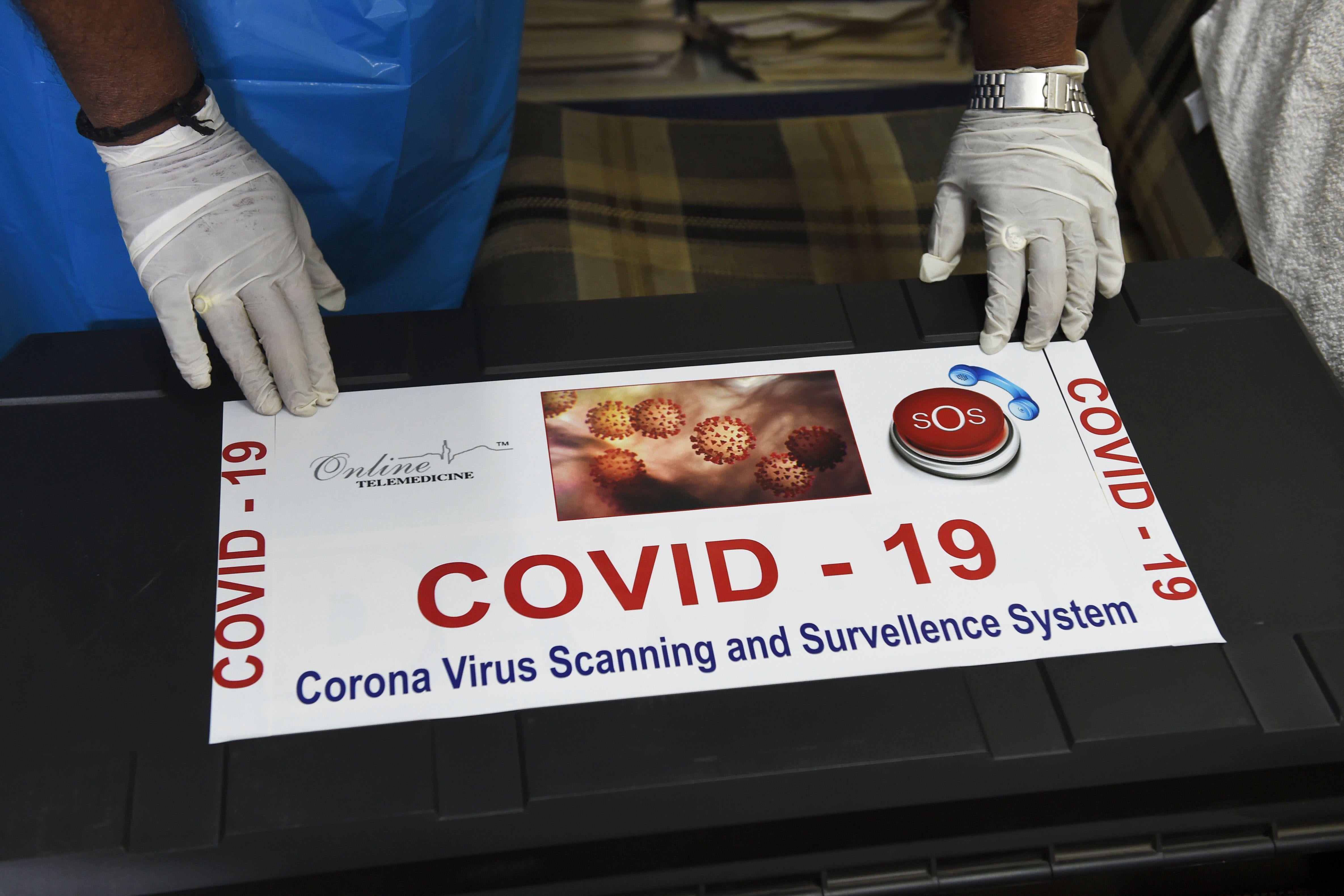 A box labeled COVID-19 scanning system.