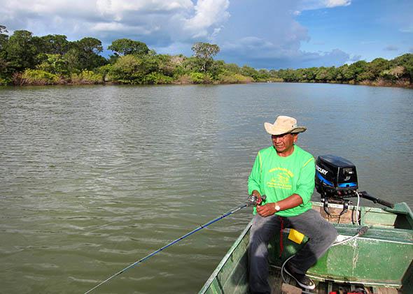 Chief Walter Javaé heads out on an afternoon fishing trip insid,Chief Walter Javaé heads out on an afternoon fishing trip inside the national park, Araguaia National Park, Brazil. February 2015.