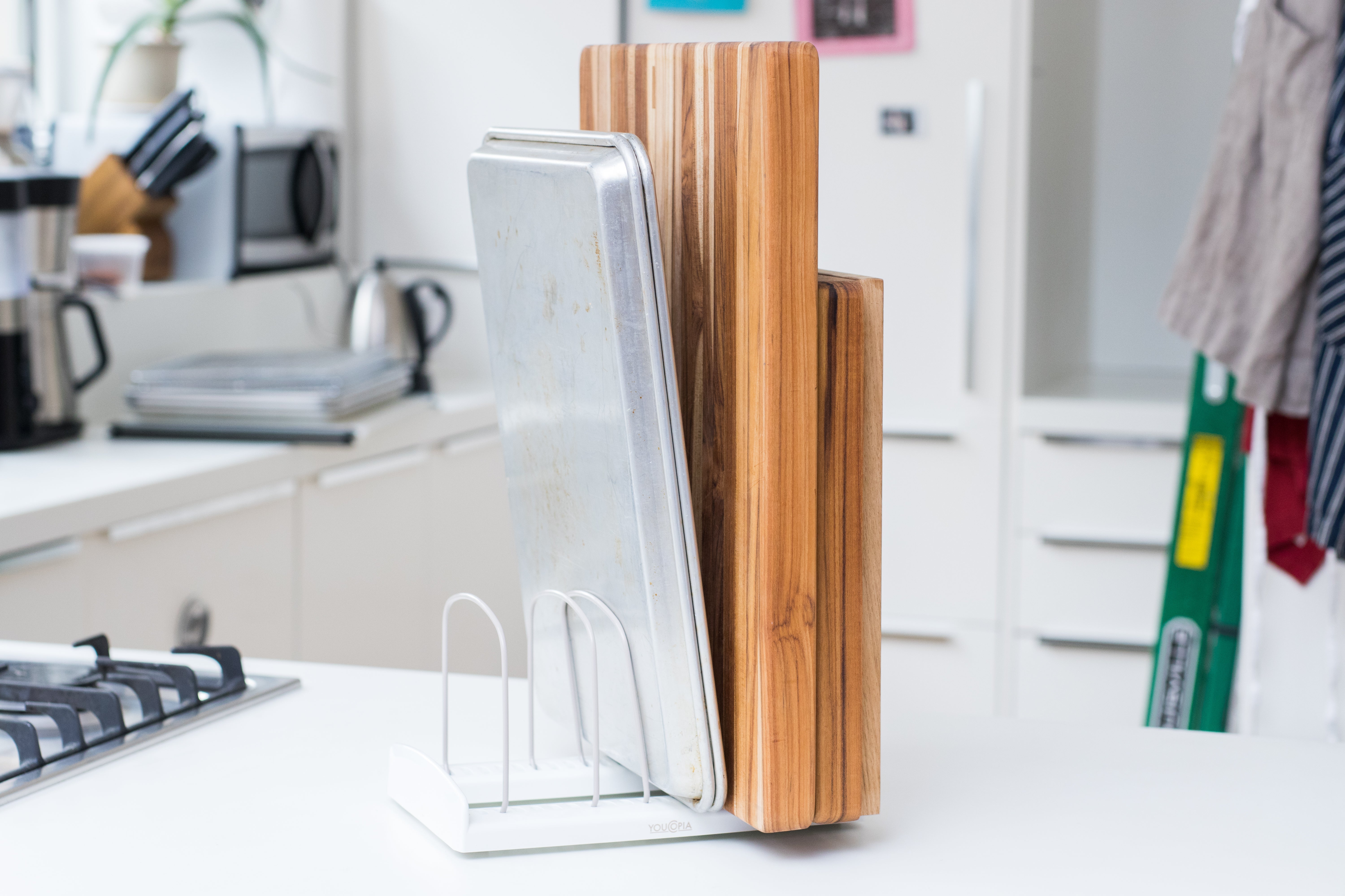 YouCopia bakeware rack with a pan and cutting boards.