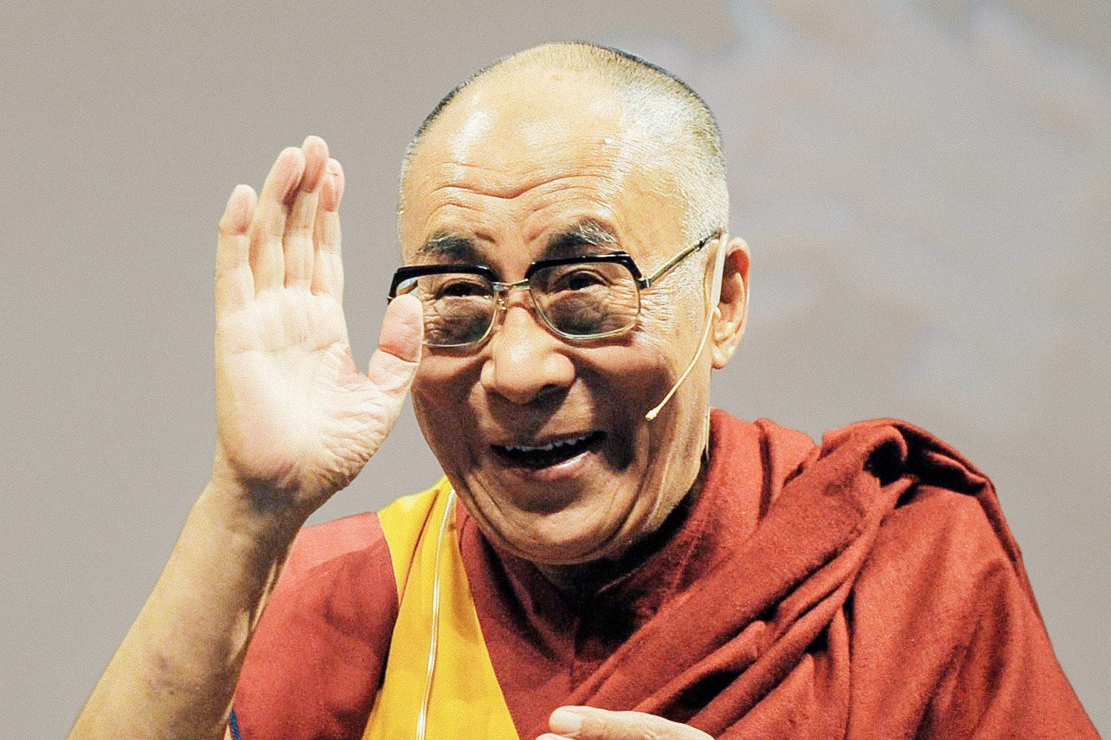 The Dalai Lama waves.