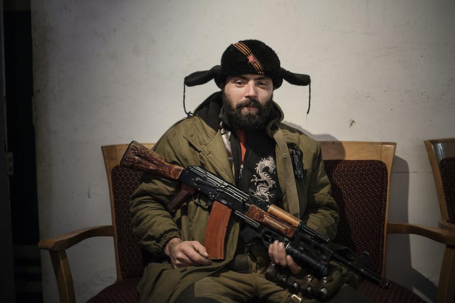 A pro-Russian rebel relaxes in a bunker close to the airport in Donetsk.