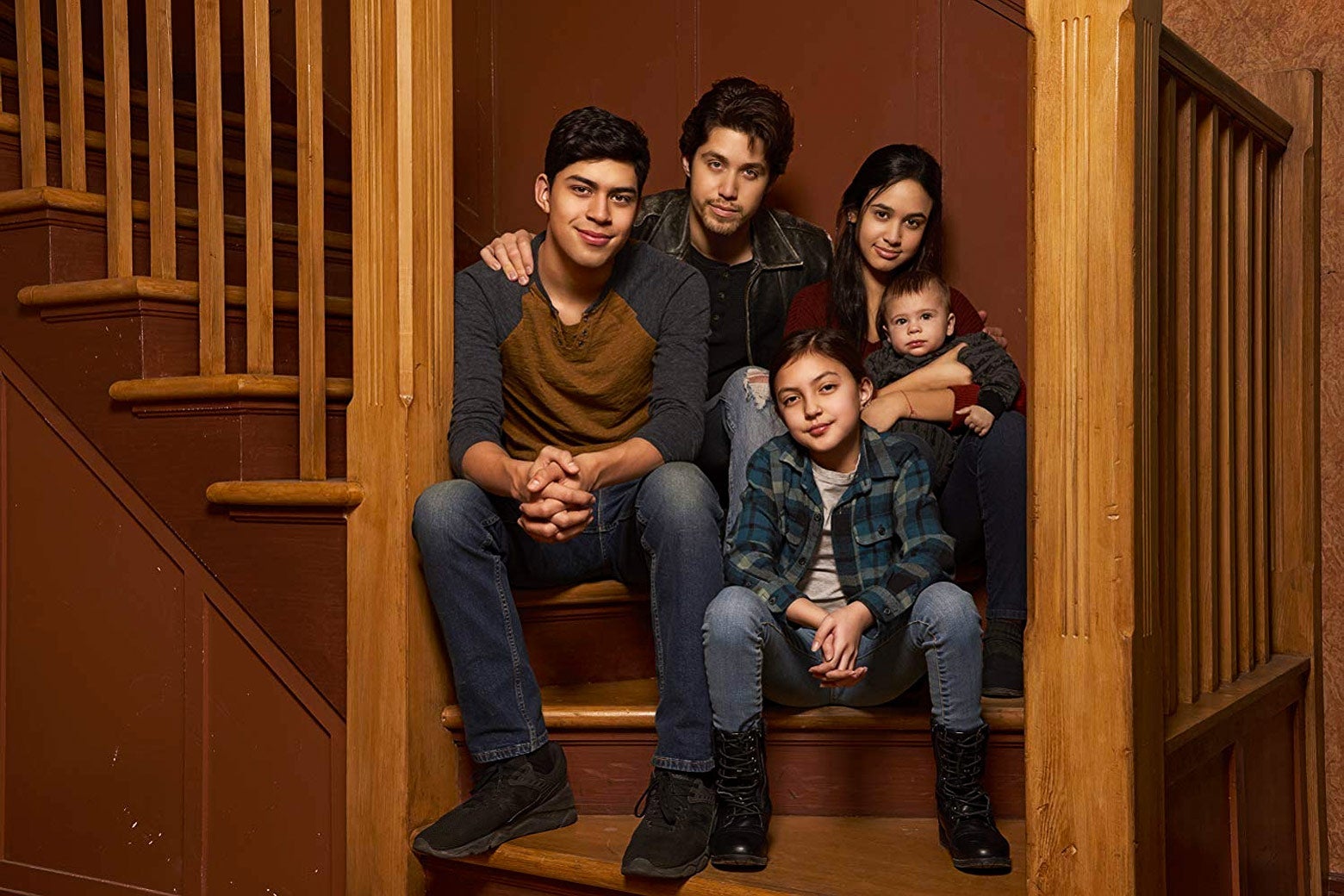 The Acosta siblings sit on the stairs together.