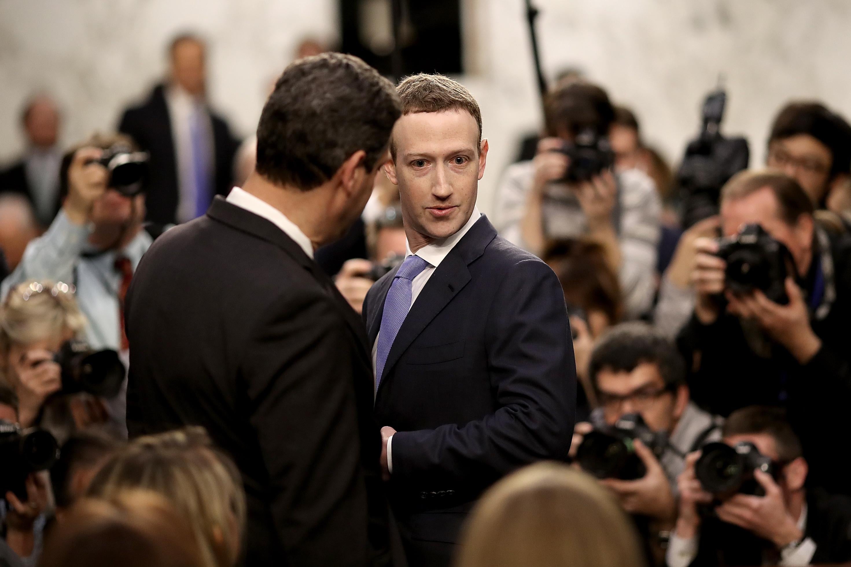 WASHINGTON, DC - APRIL 10:  Facebook co-founder, Chairman and CEO Mark Zuckerberg (R) arrives to testify before a combined Senate Judiciary and Commerce committee hearing in the Hart Senate Office Building on Capitol Hill April 10, 2018 in Washington, DC. Zuckerberg, 33, was called to testify after it was reported that 87 million Facebook users had their personal information harvested by Cambridge Analytica, a British political consulting firm linked to the Trump campaign.  (Photo by Win McNamee/Getty Images)