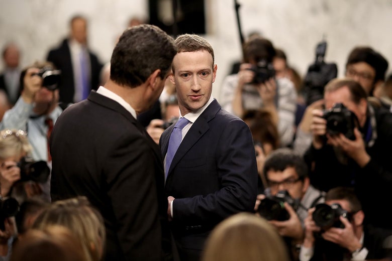 WASHINGTON, DC - APRIL 10:  Facebook co-founder, Chairman and CEO Mark Zuckerberg (R) arrives to testify before a combined Senate Judiciary and Commerce committee hearing in the Hart Senate Office Building on Capitol Hill April 10, 2018 in Washington, DC. Zuckerberg, 33, was called to testify after it was reported that 87 million Facebook users had their personal information harvested by Cambridge Analytica, a British political consulting firm linked to the Trump campaign.  (Photo by Win McNamee/Getty Images)