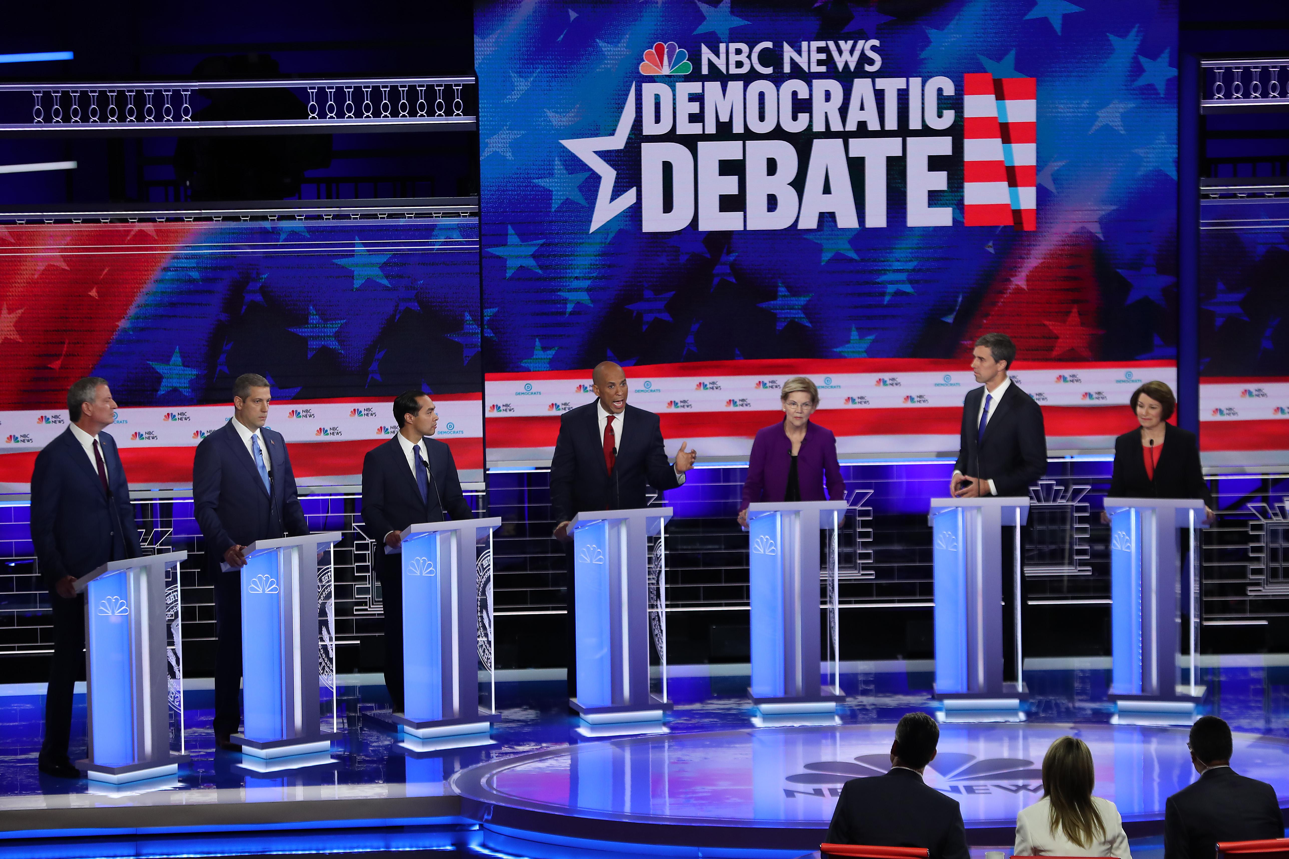 Bill de Blasio, Tim Ryan, Julian Castro, Cory Booker, Elizabeth Warren, Beto O'Rourke, and Amy Klobuchar on the debate stage.