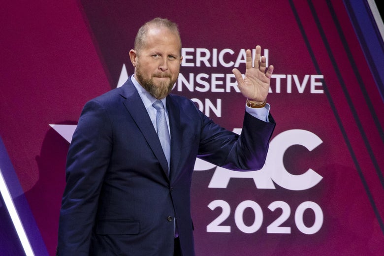 Brad Parscale waves while walking on stage in a suit during the Conservative Political Action Conference 2020.