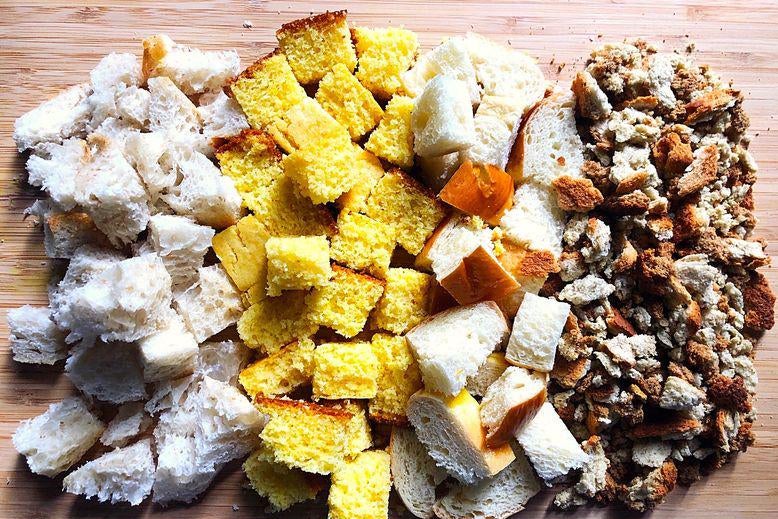 Square chunks of different kinds of bread, ranging from fine stuffing mix to thick, yellow cornbread.