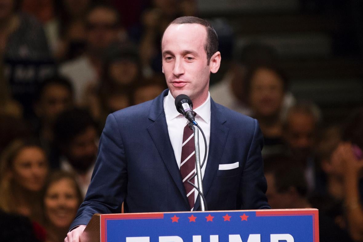 Stephen Miller at a podium that says Trump.