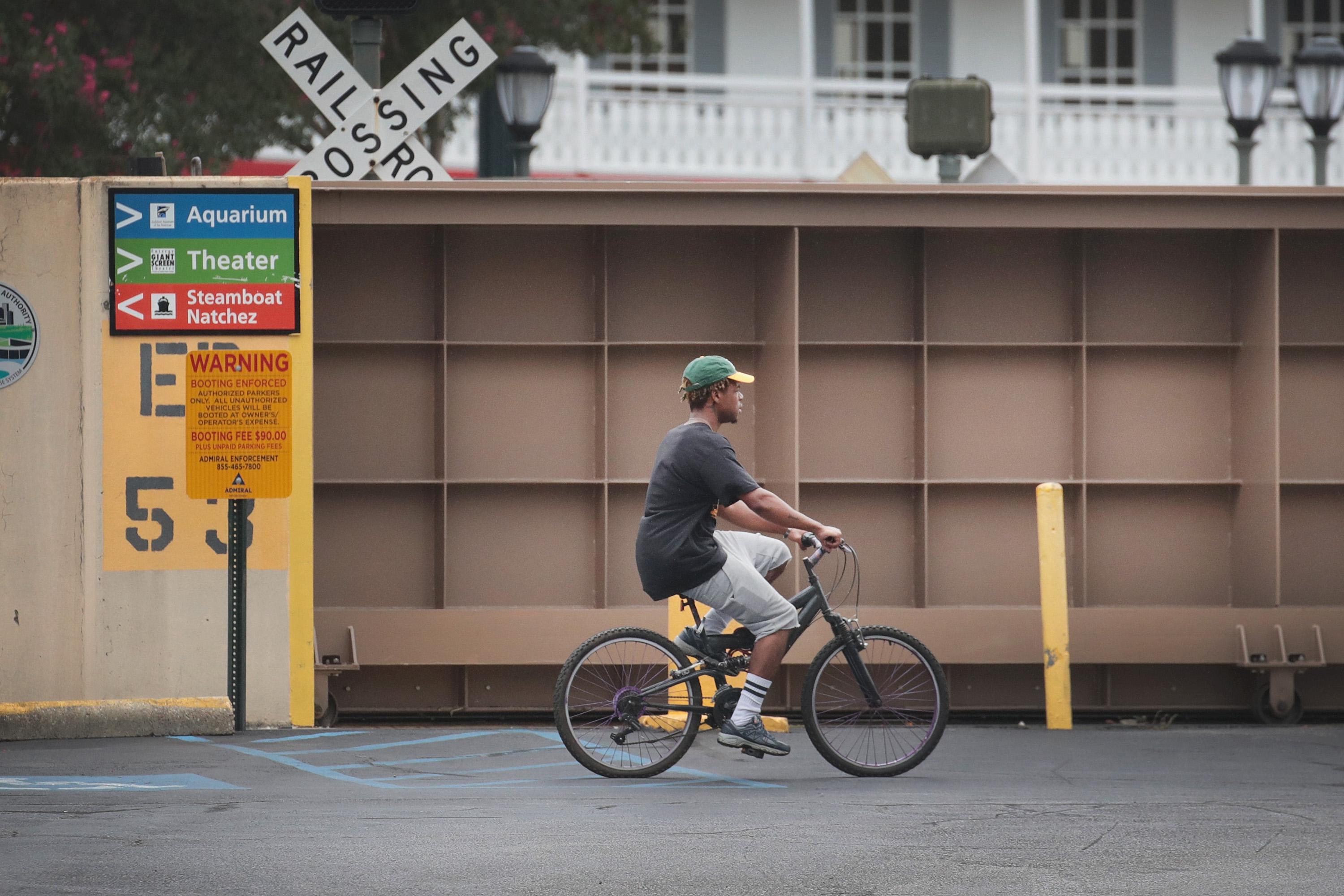 NEW ORLEANS, LOUISIANA - JULY 12: A cyclist rides past a flood gate that has been closed to keep the Mississippi River from inundating the French Quarter with storm surge from Hurricane Barry on July 12, 2019 in New Orleans, Louisiana. The slow moving storm is expected to make landfall as a tropical storm or weak hurricane near Morgan City, Louisiana. Flash flood watches have been issued over much of of Louisiana and Mississippi as the storm is expected to dump more than a foot of rain in many areas and up to 25 inches in some isolated locations.  (Photo by Scott Olson/Getty Images)