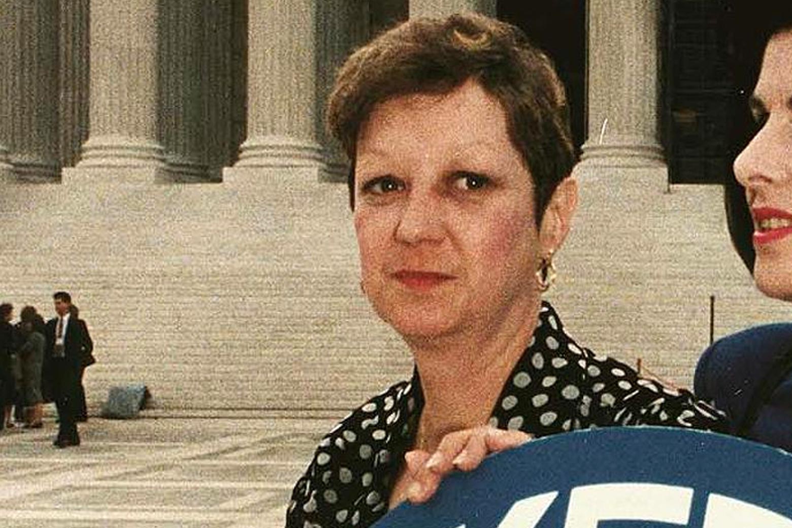 Norma McCorvey looking at the camera in front of the Supreme Court building. 