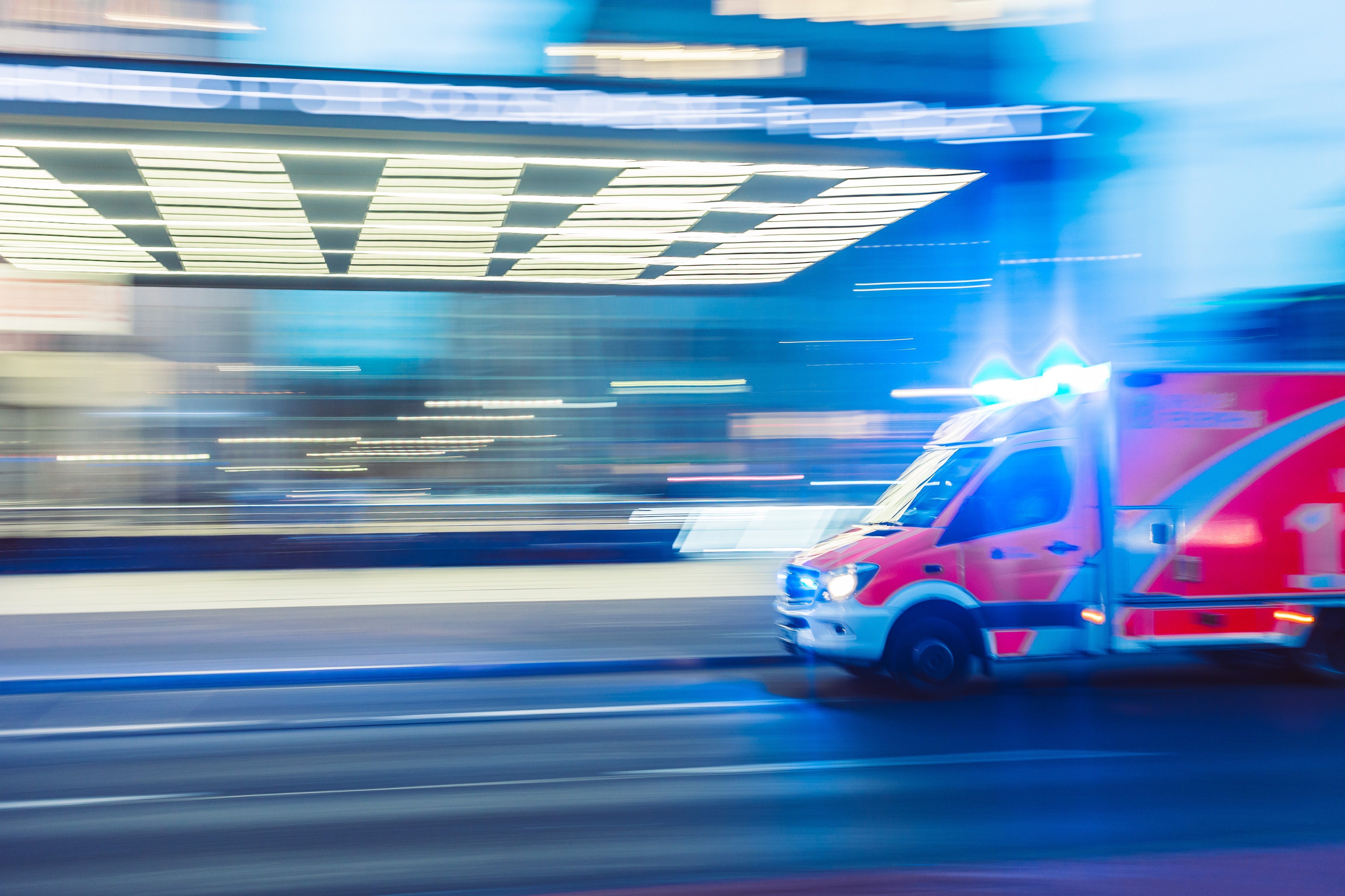 An ambulance with lights on in a time-lapse image