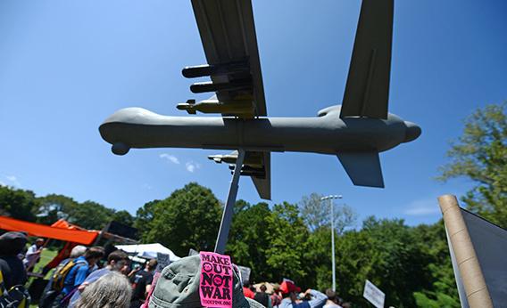 Protestors against the use of drone strikes by the US military hold a model of a drone aircraft during the "March On Wall Street South" rally in Charlotte, North Carolina, ahead of the Democratic National Convention, on September 2, 2012. 