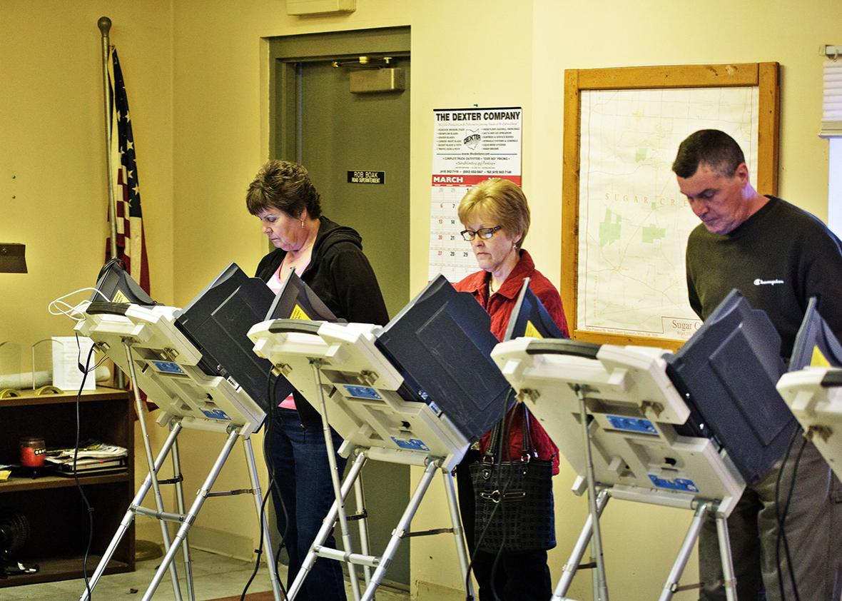 Voters use electronic machines to vote at a polling place during primary voting in Stark County March 15, 2016 in Beach City, Ohio.