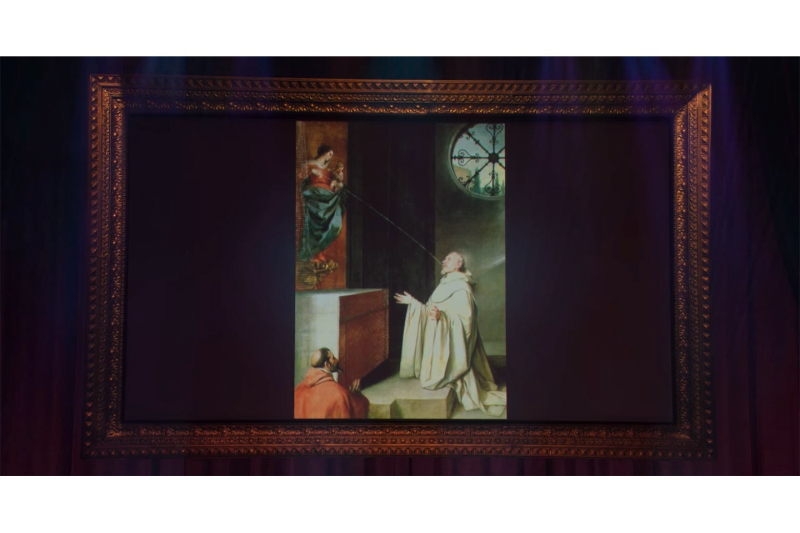 A large screen displaying a painting of Mary lactating into the mouth of St. Bernard.